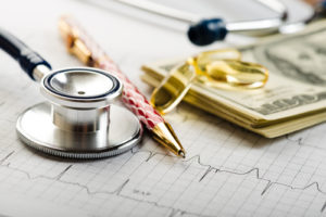 Dollars, stethoscope, pills and cardiogram. Costs for the medical insurance.