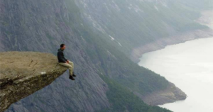 sitting at the edge of a cliff